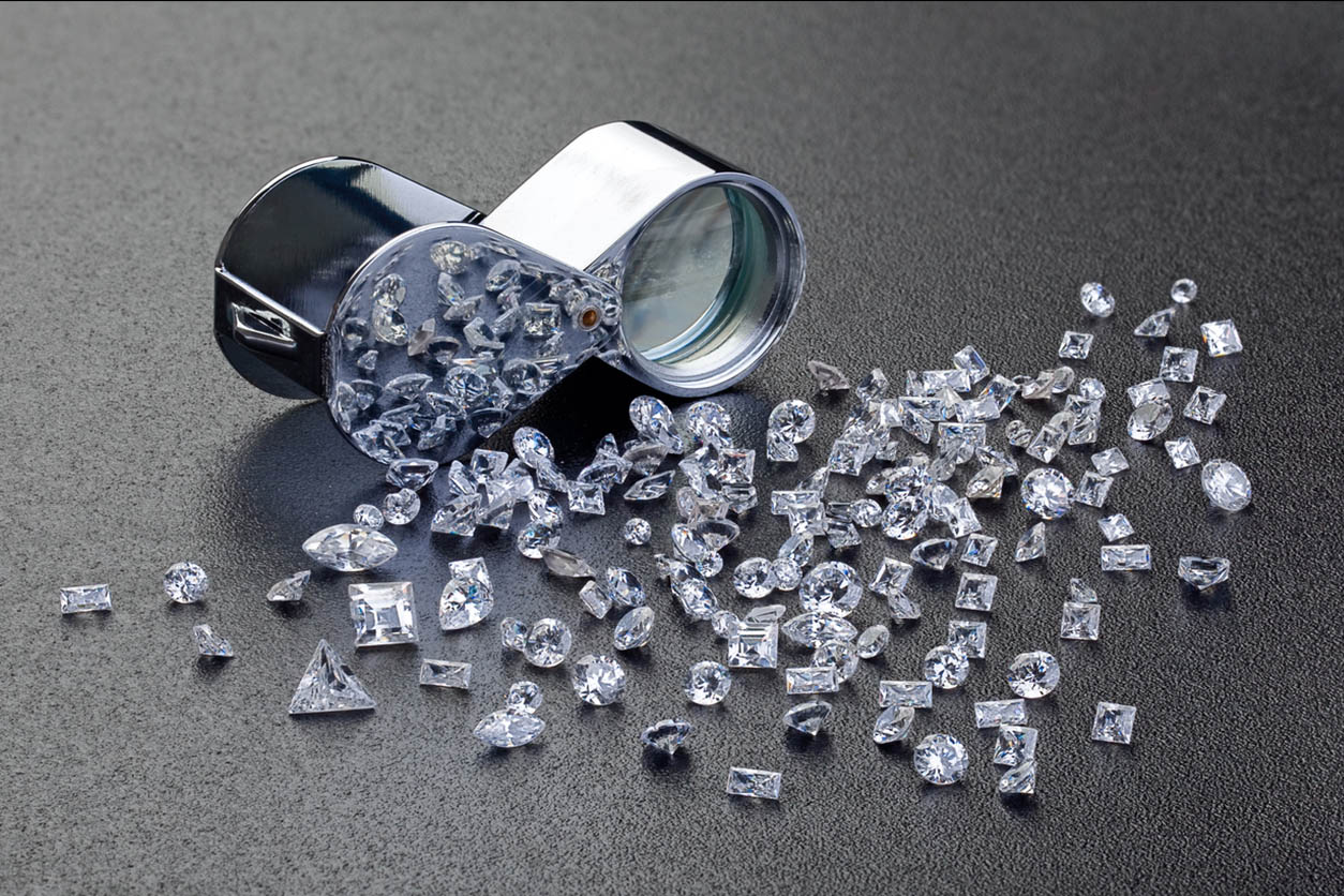 person's hands wearing a bunch of rings and bracelets, some turqoise, all silver