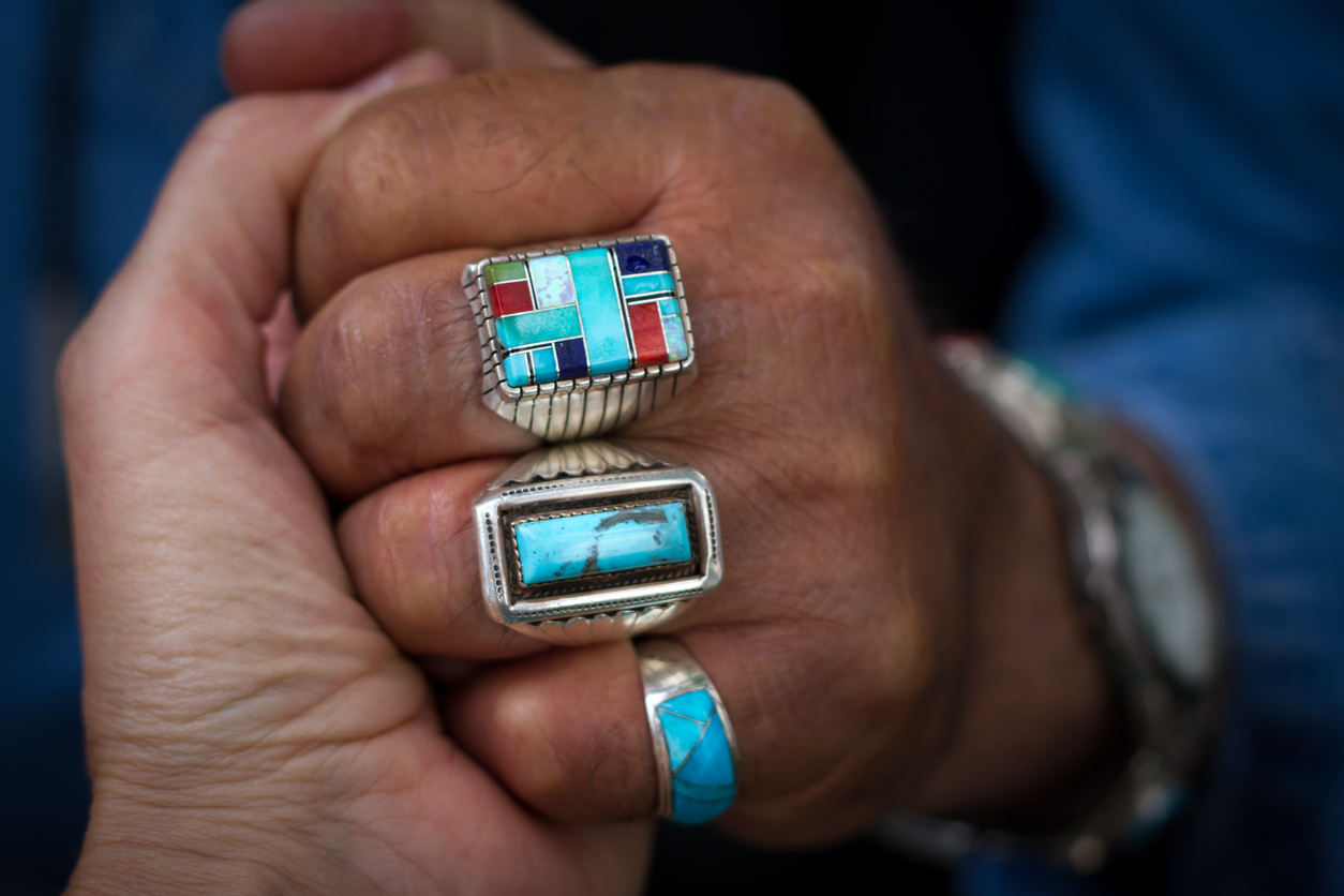 fingers with three rings turquoise, blue, multicolored