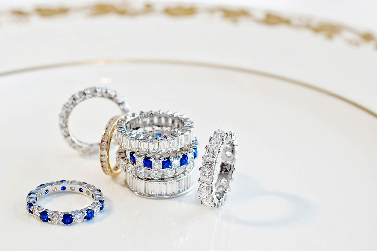 a rings of blue stones and diamonds, silver and gold