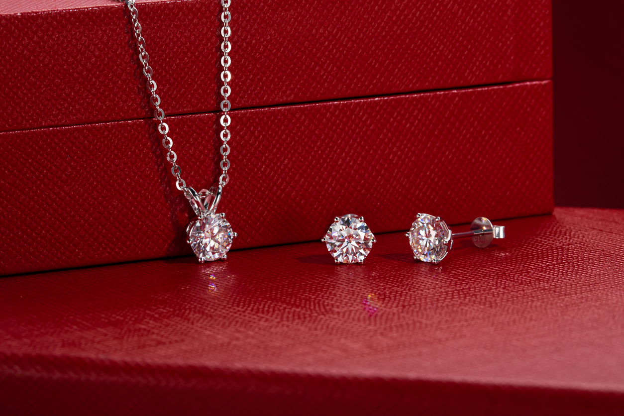 diamond necklack and diamond earings matching set on red boxes